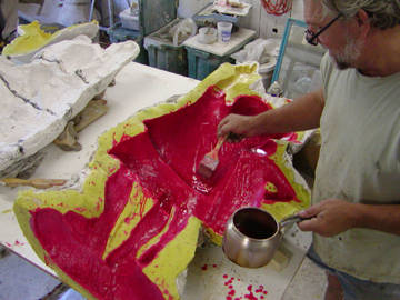 red wax is being painted into the yellow mold