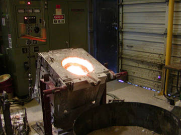 the furnace, with melting bronze